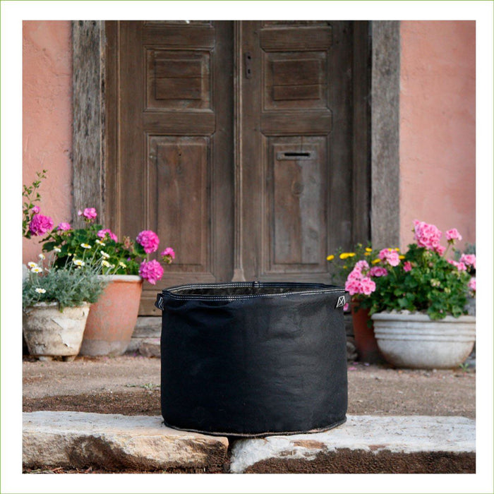 Photo of black GeoFelt Planter bag filled with soil.